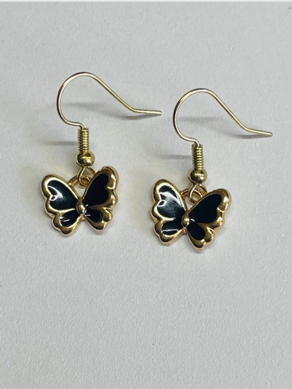 Gold Butterfly Drop Earrings with Black Enamel Accents